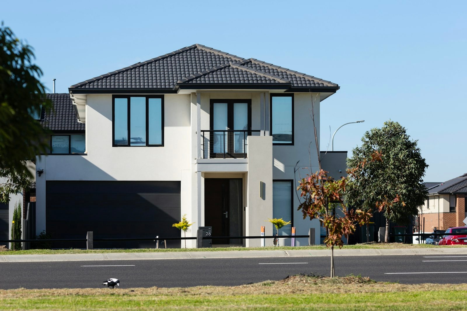 Two-story home with an attached garage and landscaped exterior